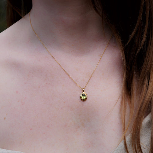 Peridot birthstone pendant necklace in brass, August gemstone jewellery on model