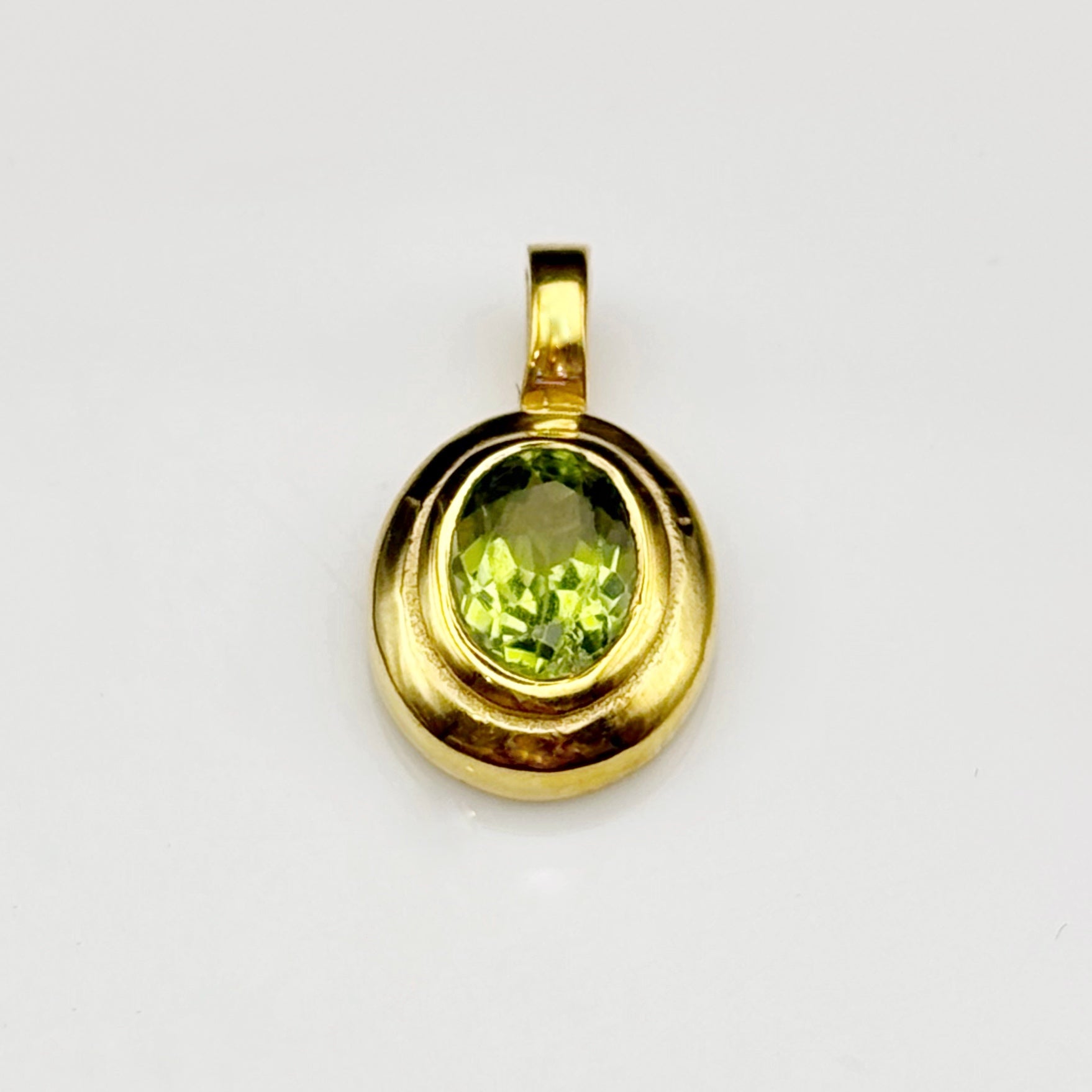 Handmade brass pendant with faceted oval peridot gemstone, August birthstone jewellery