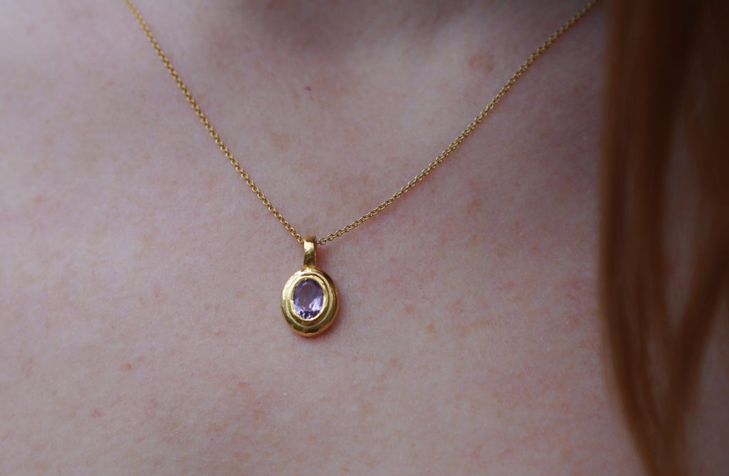 Close-up of the deep purple Amethyst stone and hand-finished golden brass setting