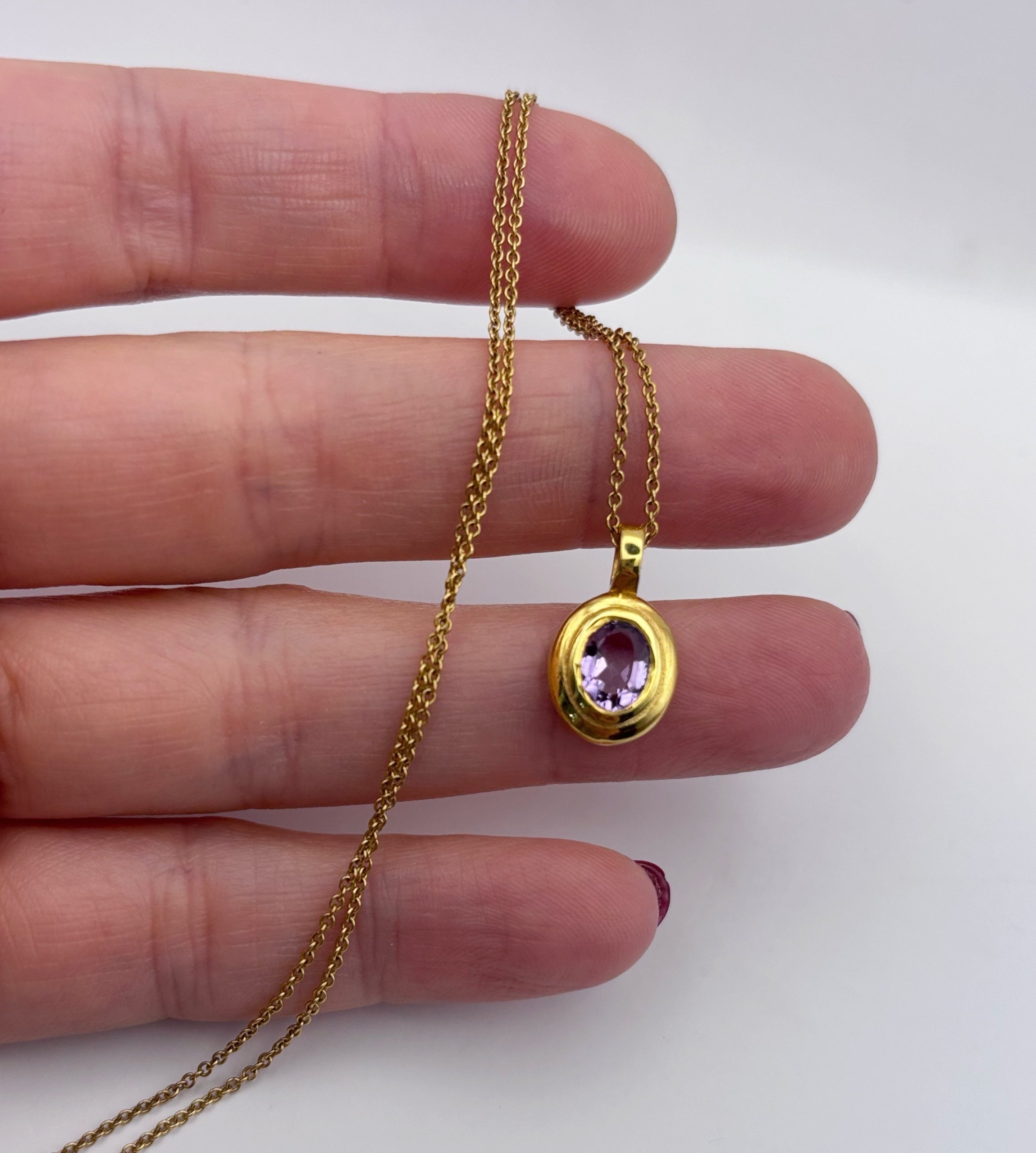 Side profile of the Amethyst pendant showing the thickness of the hand-polished brass