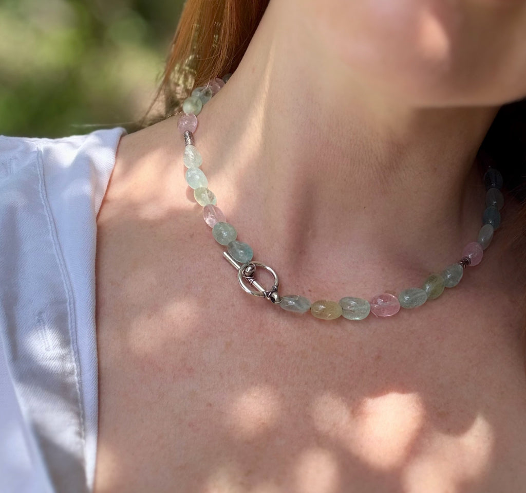 A model wearing the aquamarine necklace to show the length and how the blue stones catch the light