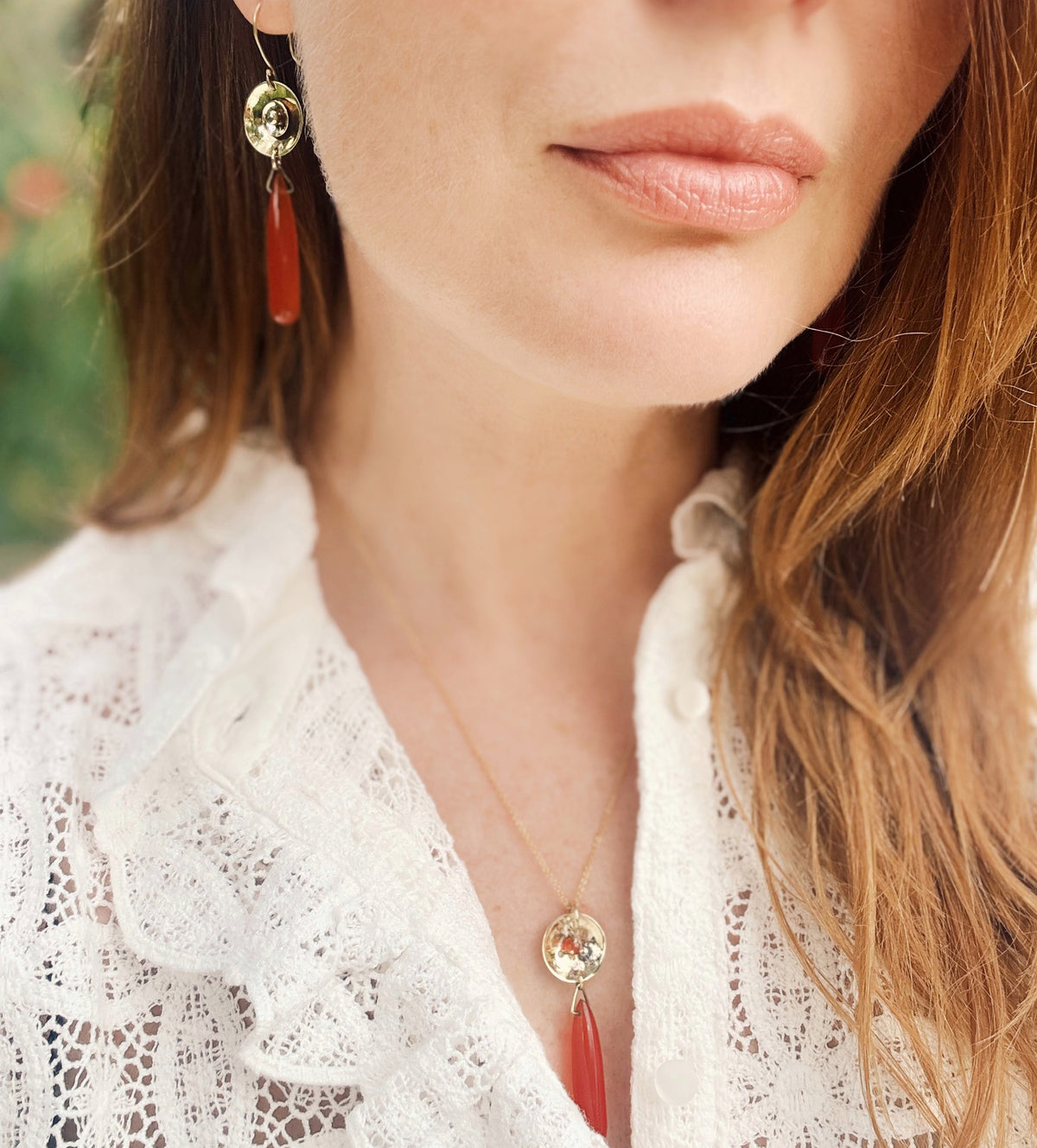 A model wearing the Carnelian and brass earrings to show the size and warm color