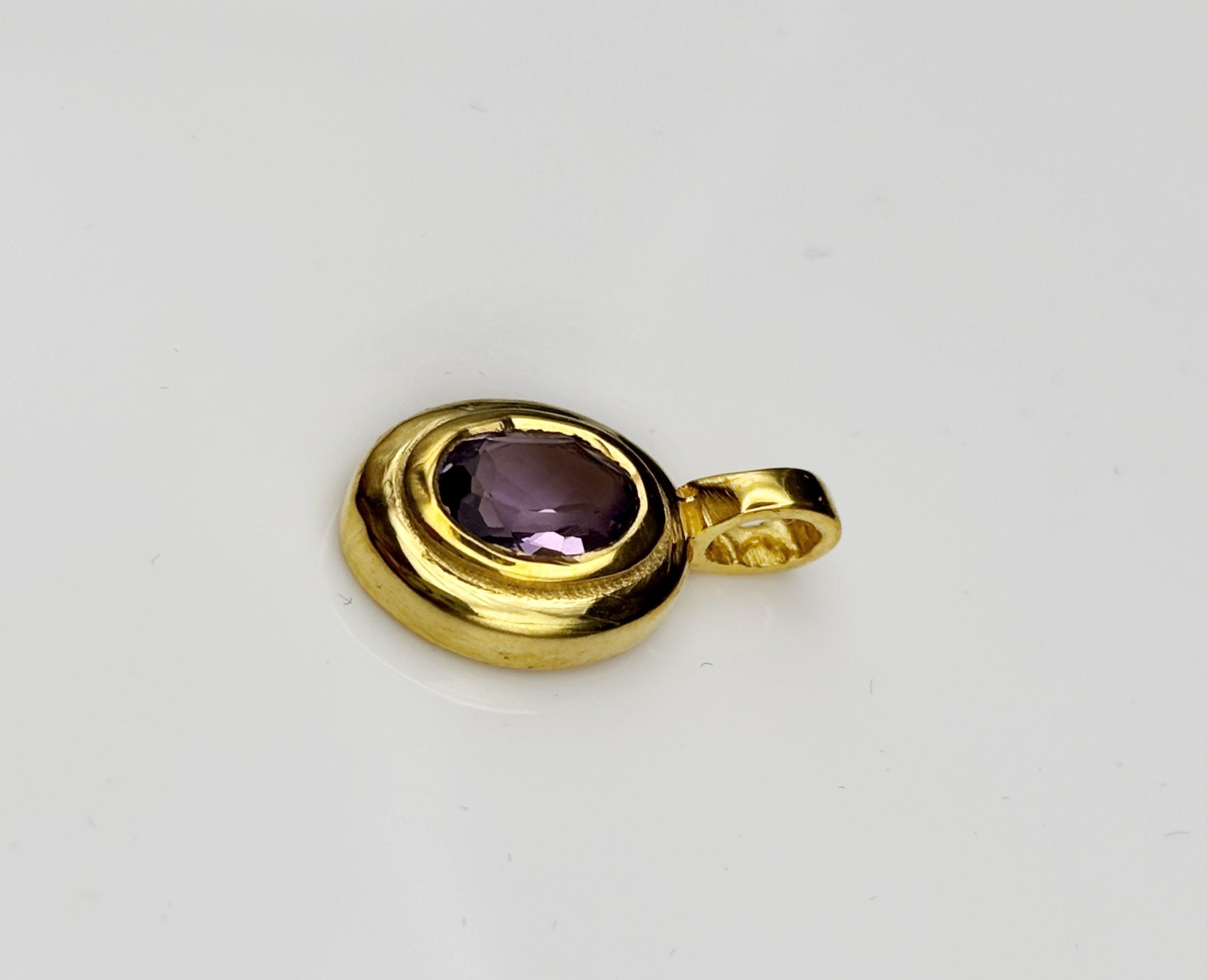 The back of the handmade brass pendant showing the secure and smooth finish